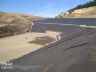 Designer for double lined landfill with steep sideslopes and benches 